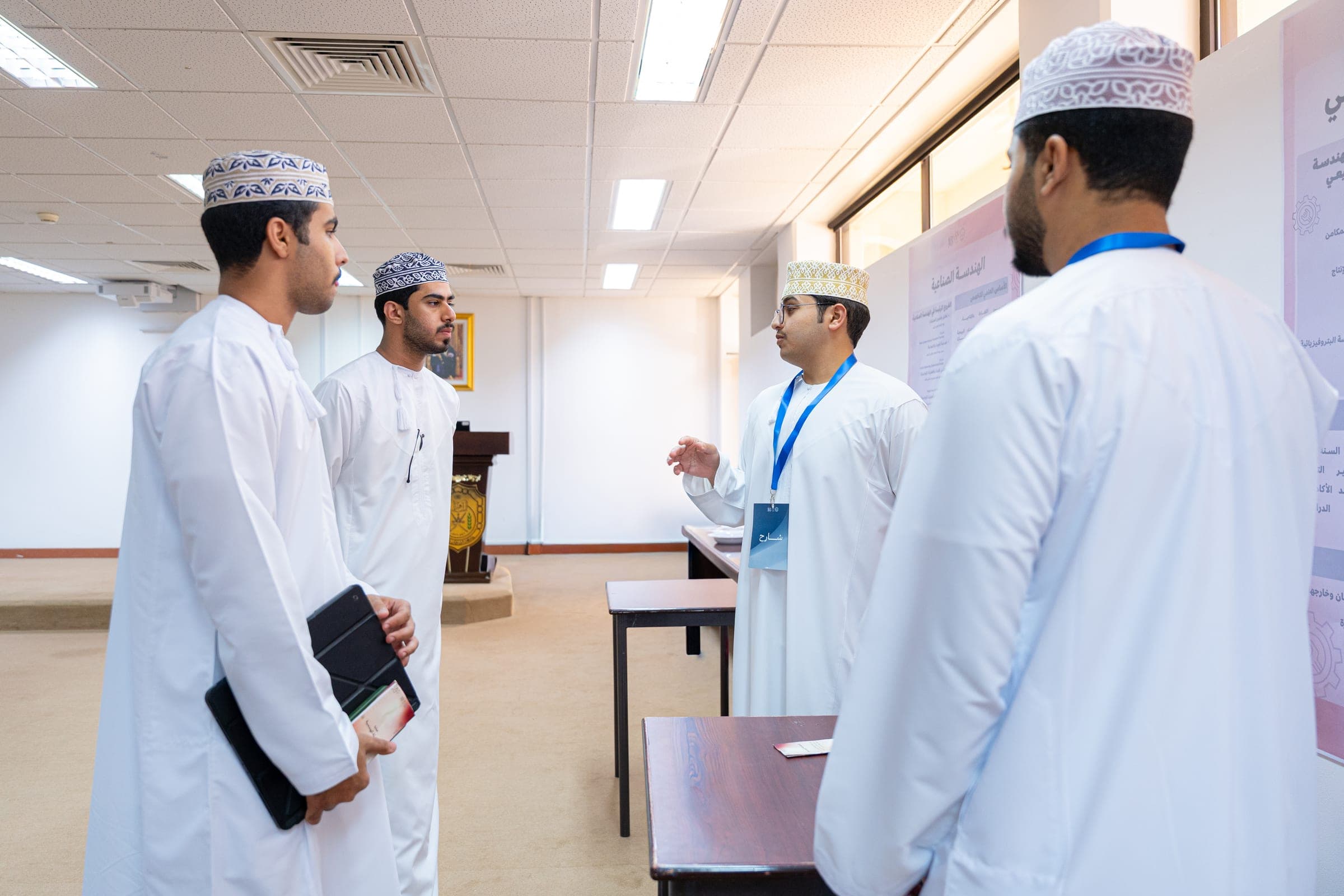 Students in conversation at the Engineering Sablah, beside the event’s posters.