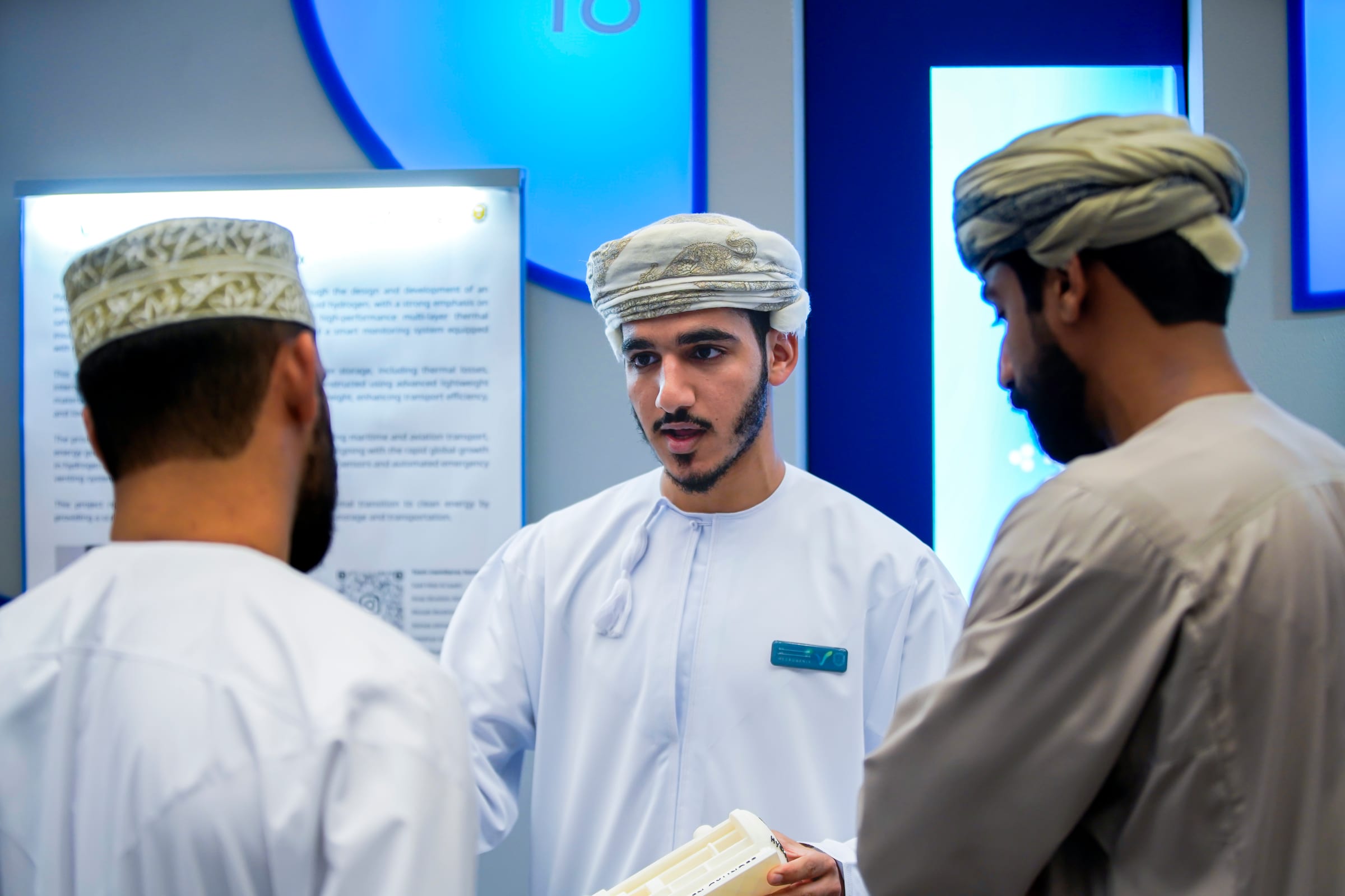 Students talk beside lit project posters at Engineering Gathering 16.